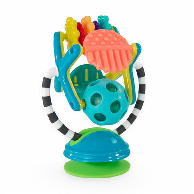 Colorful baby activity toy featuring a spinning ball, textured shapes, and a suction base for stability.