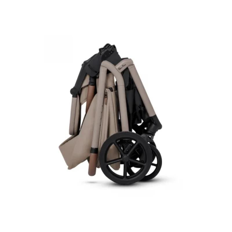 Compact Silver Cross Breez stroller in Champagne color, folded for easy storage with dark wheels and a lightweight frame.