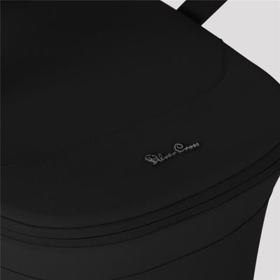 Silver Cross Breez Overnight Approved Folding Bassinet in Onyx, featuring a sleek black design and embossed logo.