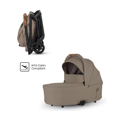 Silver Cross Nia Compact Folding Bassinet in Champagne color, featuring a folded position and an IATA cabin compliant symbol.