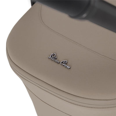 Champagne-colored fabric of the Silver Cross Nia Compact Folding Bassinet, featuring a silver logo.