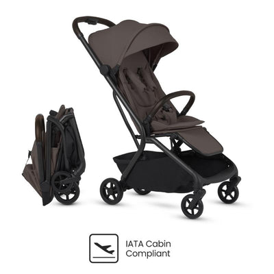 Compact travel stroller in chocolate color with a folding mechanism, safety harness, and storage basket, marked IATA Cabin Compliant.