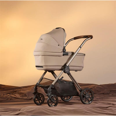Silver Cross Reef 2 modular stroller in Frappe color, featuring a beige bassinet, wooden handle, and multi-terrain wheels.