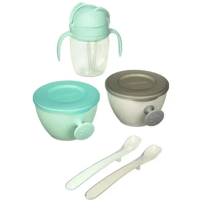 Teal and grey Skip Hop baby feeding mealtime set, including two bowls, a cup with handles, and two spoons.