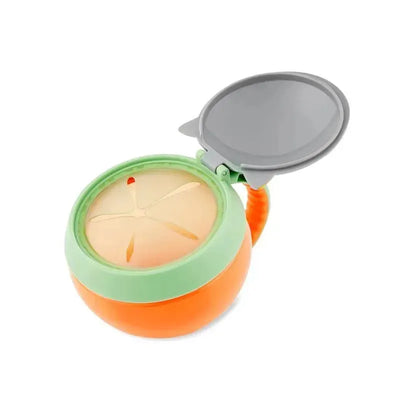 Raccoon-shaped snack cup with a green lid and orange base, featuring a removable top and cut-out for easy access to snacks.