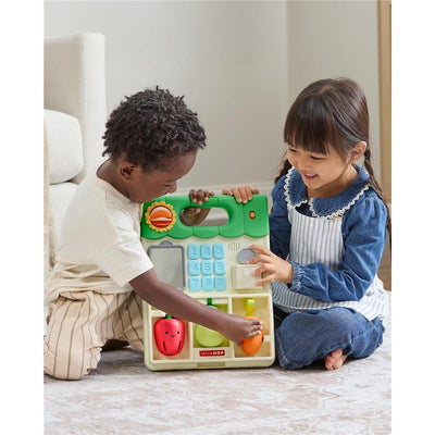 Children interacting with the Skip Hop 5-in-1 Sit to Stand Convertible Farmstand baby walker, featuring colorful fruits and a keypad.