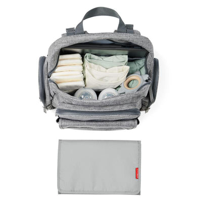 Heather grey Skip Hop Luna diaper bag backpack, open to reveal diapers, wipes, bottles, and a portable changing pad below.
