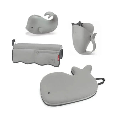 Grey Moby Baby Bath Essential Set from Skip Hop featuring a whale-shaped bath toy, pitcher, and a bath mat.