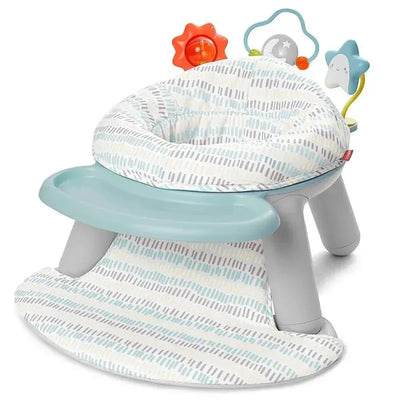 2-in-1 activity floor seat with a plush cloud pattern, safety harness, and toy attachments featuring a sun, moon, and star.