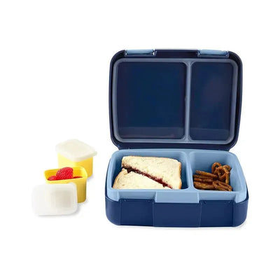 Bento lunch box with divided compartments containing a sandwich, pretzels, and two small containers with raspberries.