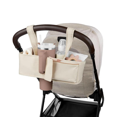 Universal stroller organizer by Skip Hop in Oat color, featuring compartments for drinks, baby bottles, and accessories.