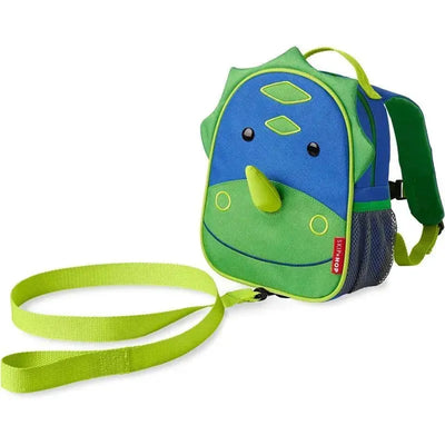 Dino-themed Skip Hop Zoo Mini Backpack in blue and green, featuring eyes, a snout, and a detachable strap.