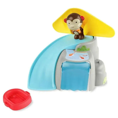 Monkey-shaped toy on a colorful outdoor playset with a slide and water feature.