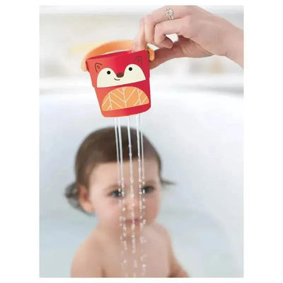 Colorful red fox-shaped bucket pouring water over a young child in a bath setting.