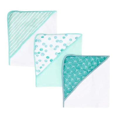 Three soft terry hooded towels in green dot and patterned designs, featuring turquoise trims and varying patterns.