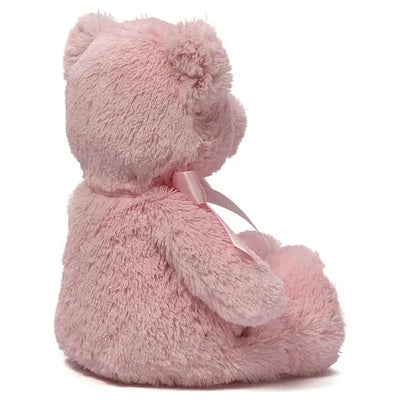Pink plush teddy bear with a ribbon, designed for young children as a soft toy.