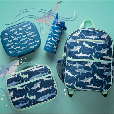 Bento box with removable tray and shark designs, alongside a matching lunch bag, backpack, and water bottle on a teal background.