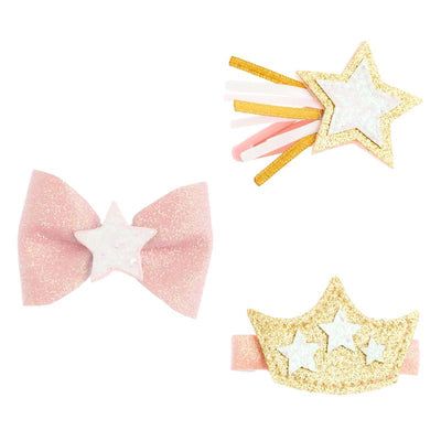 Three hair clips: a pink glitter bow with a star, a golden star with ribbons, and a crown with stars.
