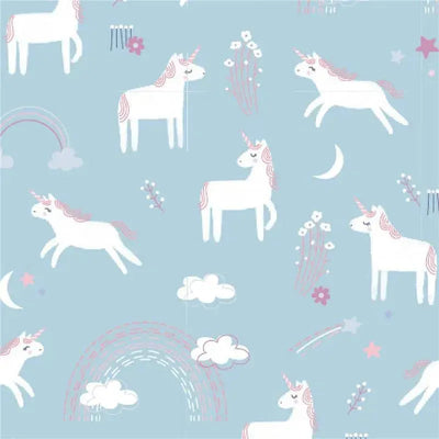 Muslin baby blankets featuring a whimsical unicorn pattern with rainbows and clouds on a light blue background.