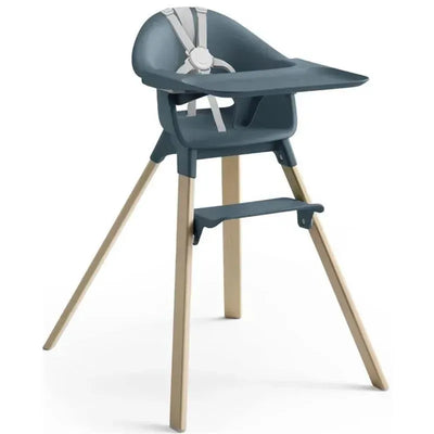Stokke Clikk High Chair in Fjord Blue with a minimalist design and wood legs, featuring a safety harness and footrest.