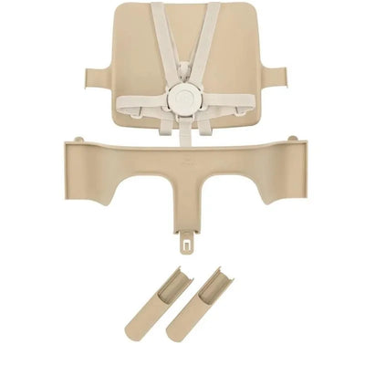 Beige Stokke Tripp Trapp High Chair accessories, including a backrest, safety harness, and two clips.