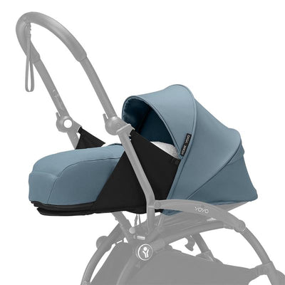 Stokke Yoyo 0+ Newborn Pack in Aqua, featuring a soft padded seat with a hood and a sleek black and aqua design.