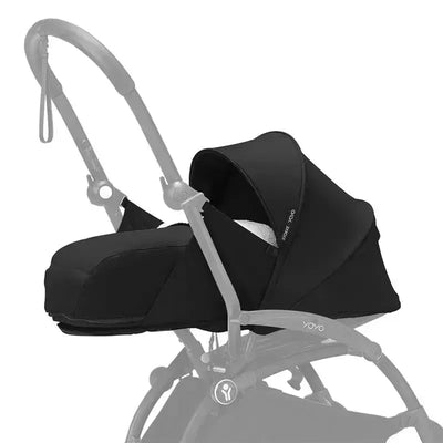Newborn pack for Stokke Yoyo stroller in black, featuring a protective canopy and soft interior for infants.