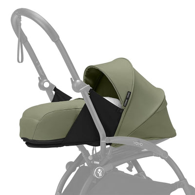 Newborn Pack for Stokke Yoyo stroller in olive green with black accents, featuring a protective canopy and cushioned interior.
