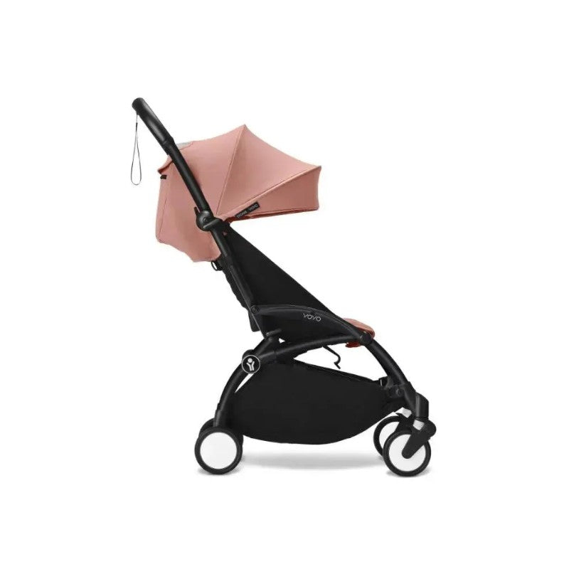 Stokke Yoyo³ stroller in black frame with ginger seat and canopy, designed for children 6 months and up.