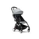 Stokke Yoyo³ stroller with a black frame and stone bundle leg rest, featuring a lightweight design and adjustable canopy.