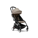 Stokke Yoyo³ stroller in a black frame with a taupe seat and canopy, designed for children aged 6 months and up.
