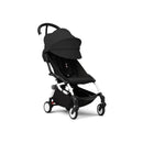 Stokke Yoyo³ stroller in black with a white frame, featuring a foldable design and ample leg rest.
