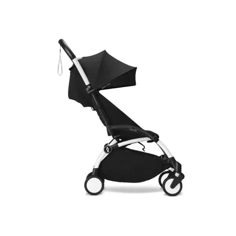 Stokke Yoyo³ stroller in black with a white frame, featuring a large canopy and adjustable leg rest.