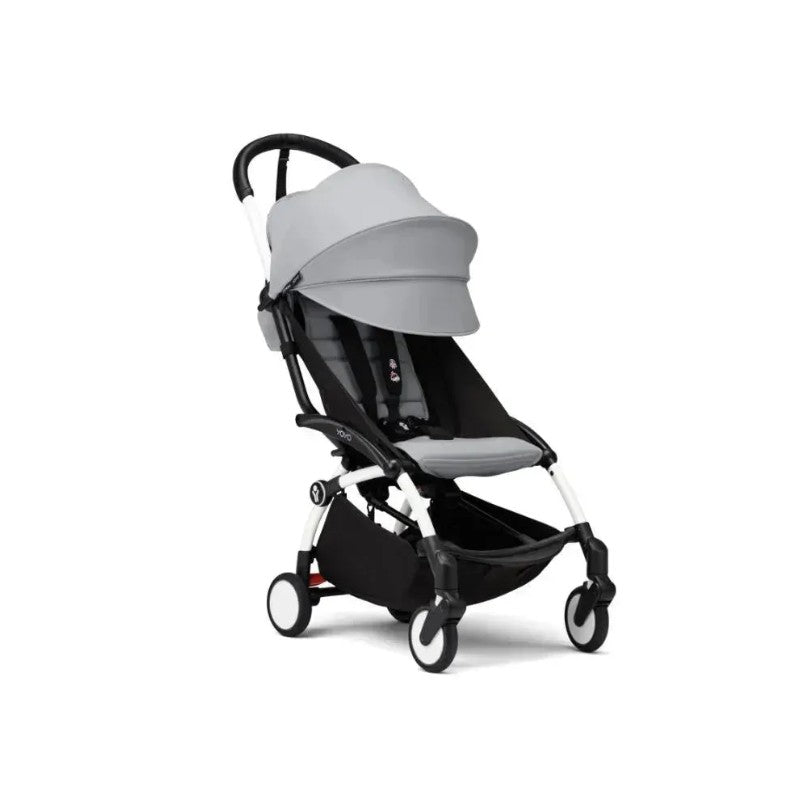 Stokke Yoyo³ stroller in white frame with stone fabric, features a folding design and adjustable canopy.