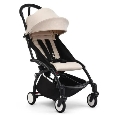Stokke Yoyo³ Stroller in black with a beige seat, featuring a large canopy and safety harness for children 6+.