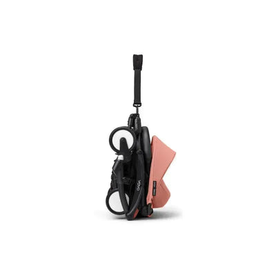 Stokke Yoyo³ stroller in black with ginger fabric, shown in a compact, folded position for portability.