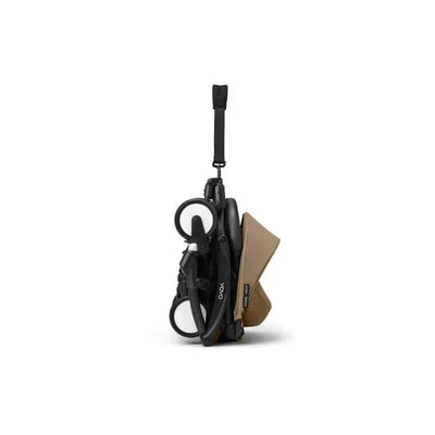 Stokke Yoyo³ stroller in black with toffee-colored fabric, shown in a compact, folded position.