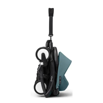 Compact Stokke Yoyo³ stroller in aqua with a black frame, displayed in a folded position for easy transport.