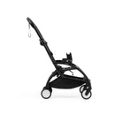 Stokke YOYO5 Car Seat Adapters mounted on a lightweight black stroller, showcasing a compact design and sturdy wheels.