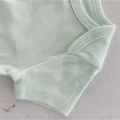 Soft jadeite organic cotton bodysuit showcasing the sleeve and neckline details, part of a three-pack set.