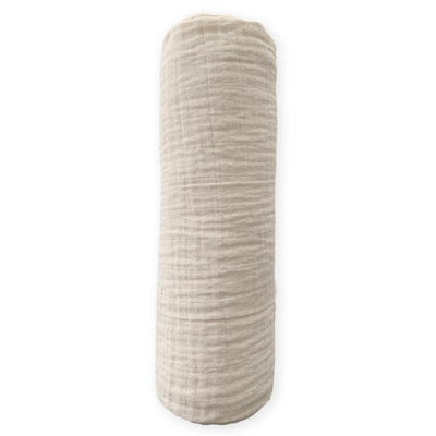 Oatmeal-colored muslin swaddle blanket, rolled up, featuring a soft, textured fabric ideal for wrapping infants.