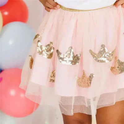 Baby girl crown tutu dress-up skirt in pink tulle with gold sequin crowns, paired with a white top.