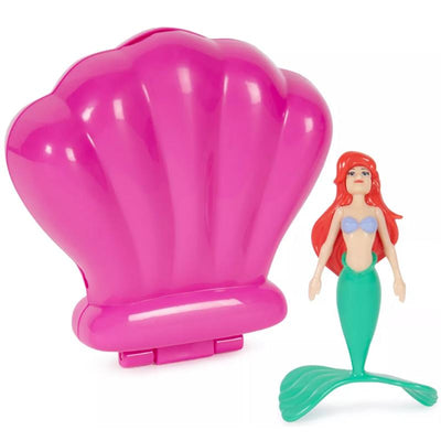 Swimways Ariel Dive N Surprise set featuring a pink clamshell and a mermaid figurine with a green tail and long red hair.