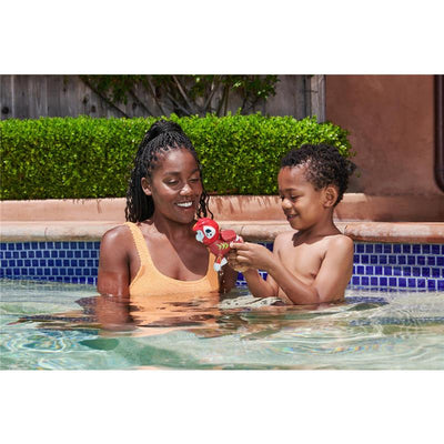 Mother and son play in a pool, with the boy holding a red Paw Patrol floating figure.