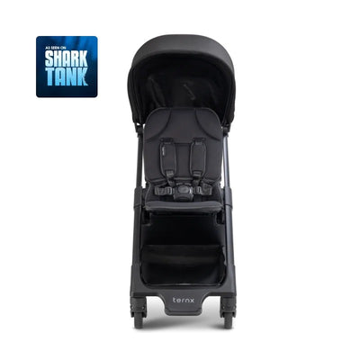 Ternx Carry On Luggage Stroller in black and grey, featuring a padded seat, safety harness, and storage compartment.