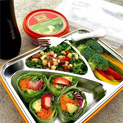 Blue Go2 plastic container with fresh salad, colorful vegetables, hummus, and a stainless steel fork.