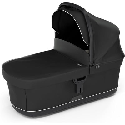 Black Thule Bassinet with a sunshade, featuring a sleek design and zippers for easy access and functionality.