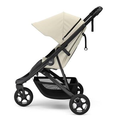 Thule Spring 2 single child stroller in soft beige, featuring adjustable canopy and black frame with large wheels.