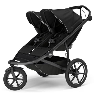 Thule Urban Glide 3 double stroller in black featuring two seats, adjustable canopies, and a spacious storage basket.