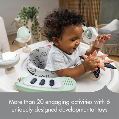 Tiny Love 5-in-1 Here I Grow Activity Center featuring a happy baby playing with soft toys and interactive buttons.